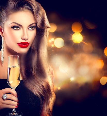 _girl-with-glass-of-champagne-at-party-over-holiday-glowing-